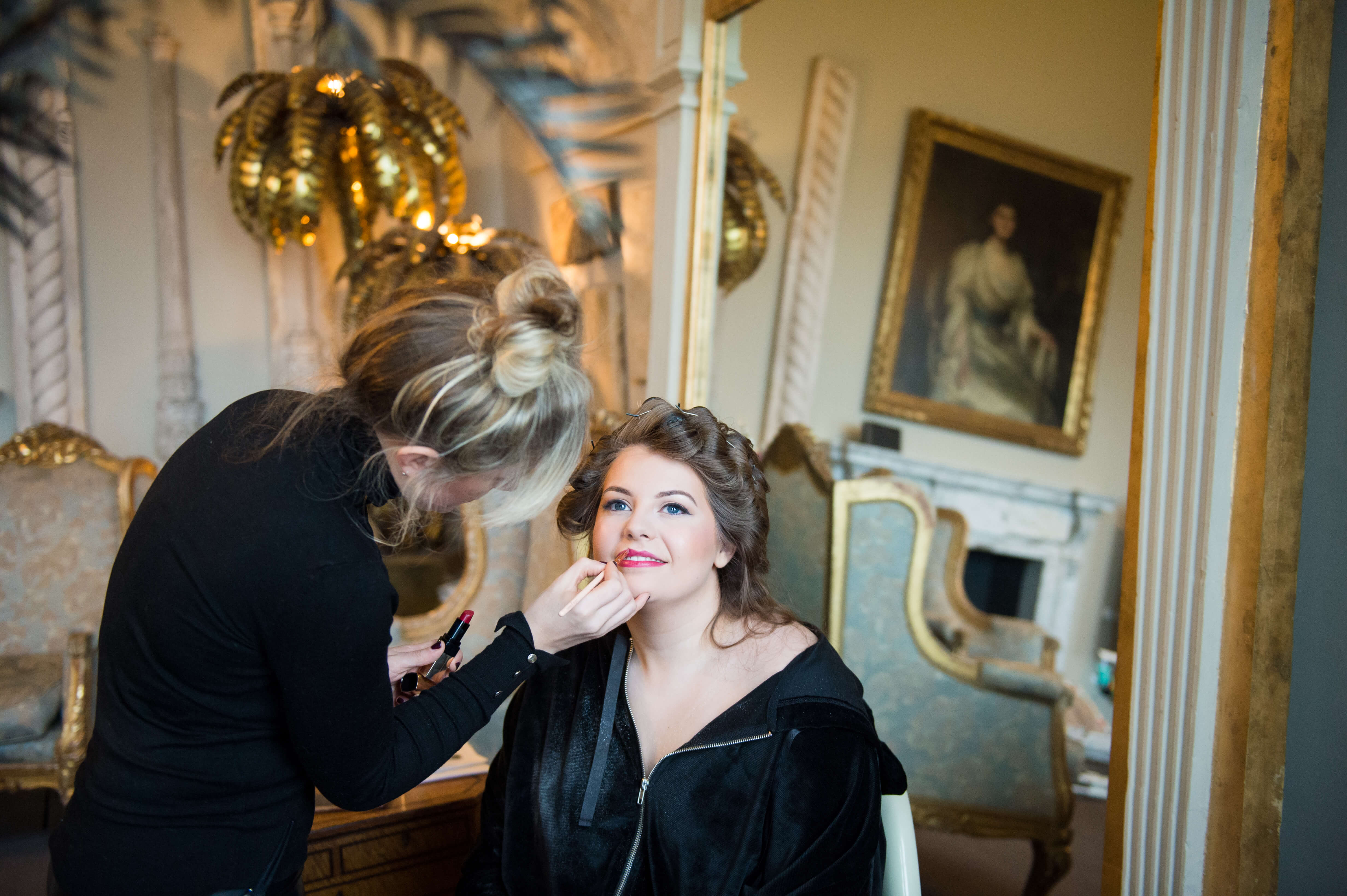 A bride having her hair and make up done at aynhoe house by oxford hair and make up